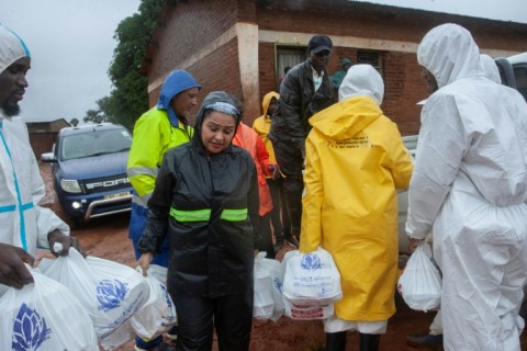 Water Sanitation  Minister Abida Mia (2nd L) carries relief food for to mudslide victims at Chilobwe township in Blantyre