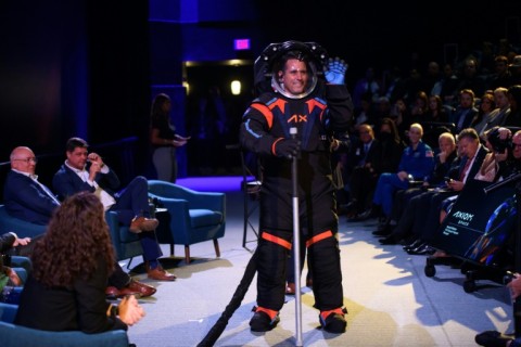 The spacesuit modeled by Jim Stein featured a cover layer in all black with blue and orange trim which Axiom Space said was required to 'conceal the suit's proprietary design'