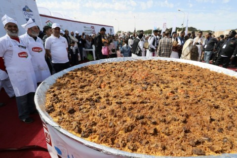 Libyan chefs and people gather around a giant couscous, on the site of the ancient Roman theatre of Sabratha, about 70 km west of the capital Tripoli