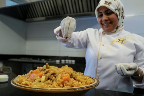 Libyan chef Monira Zwait prepares a coucous in the kitchen of her restaurant in Tripoli