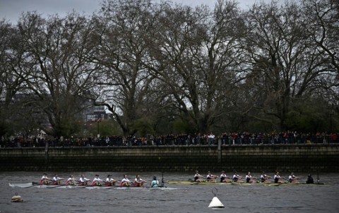 Cambridge lead Oxford (R) in the 77th annual women's university boat race on London's River Thames