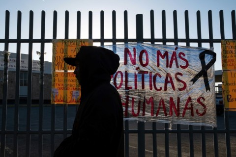 'No more inhuman policies,' reads a sign outside the detention center where 38 migrants died in a fire in northern Mexico