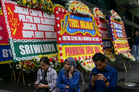 Floral boards of condolences for the players were left outside the offices of the Indonesian football association