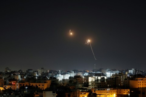 Streaks of light are seen in the sky as Israeli air defences intercept rocket fire from the Gaza Strip
