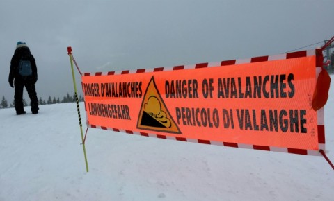 This file photo taken in 2016 in the French Alps shows a banner indicating a high risk of avalanche