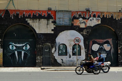 Motorcyclists drive past the closed Saudi embassy in Sanaa