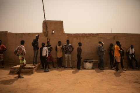 Quest for help: Migrants wait outside the Arlit offices of the International Organization for Migration