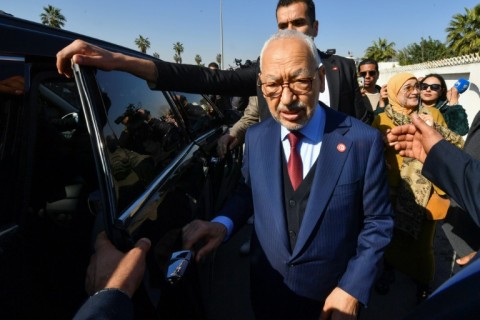 Rached Ghannouchi, the head of Tunisia's Islamist-inspired party Ennahdha, greets supporters upon arrival at a police station in Tunis, on February 21, 2023