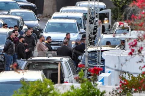 Members of Tunisia's security forces gather during the raid to arrest Ghannouchi at his home