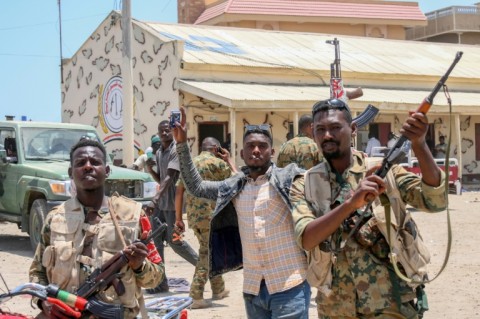 Sudanese army soldiers, loyal to army chief Abdel Fattah al-Burhan, pose for a picture at the Rapid Support Forces (RSF) base in the Red Sea city of Port Sudan on April 16