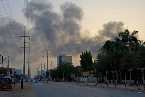 Smoke billows above residential buildings in Khartoum on April 16 as fighting raged