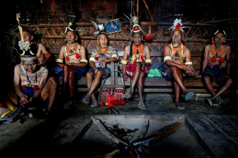 Konyak tribesmen gather at a traditional tribal house in Hongphoi village