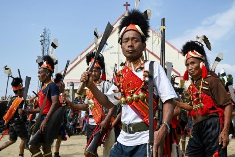 Konyak tribesmen dance with guns and sickle at a community gathering in Longwa village in India's Nagaland state