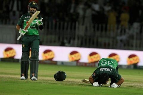 Moment of celebration: Pakistan's Fakhar Zaman (right) celebrates after scoring his century on Thursday
