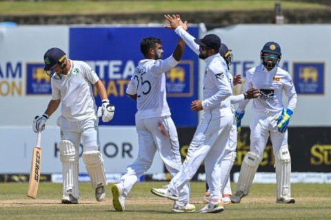 Sri Lanka's Ramesh Mendis (2L) celebrates with teammates after taking the wicket of Ireland's Andrew McBrine