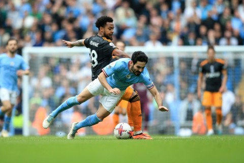 Action man: Manchester City's Ilkay Gundogan tussles with Weston McKennie of Leeds