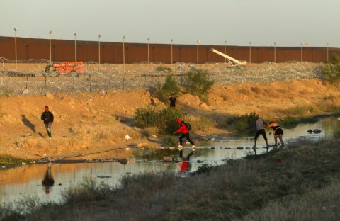 Migrants cross the Rio Grande river from Ciudad Juarez in northern Mexico to surrender to US Border Patrol agents 
