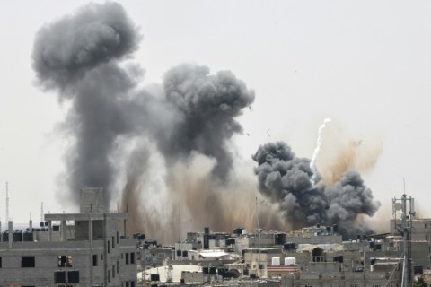 Smoke rises above buildings in Rafah in the southern Gaza Strip following an Israeli strike on May 12, 2023