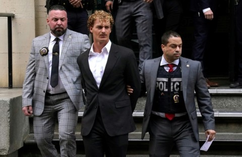US Marine veteran Daniel Penny (C) is walked out of the New York Police Department 5th Precinct in Lower Manhattan, May 12, 2023, on his way to an arraignment for charges in the chokehold death of Jordan Neely
