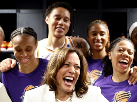US Vice President Kamala Harris (center) laughs with Brittney Griner (top) and other Phoenix Mercury players before their game in Los Angeles on Friday