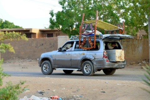 The exodus continues -- people flee with their belongings from Khartoum's twin city of Omdurman