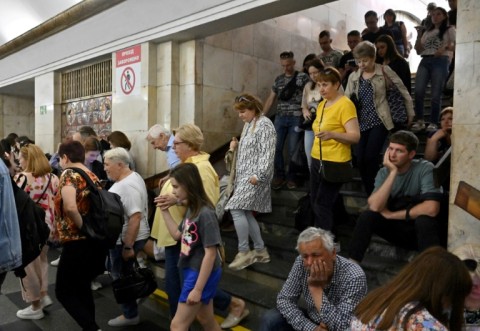 Residents take shelter in a metro station in the centre of Kyiv during a Russian missile strike 