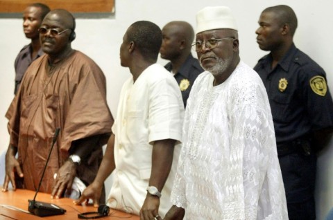 Allieu Kondewa, left, next to Moinina Fofana, in white, at the star of their trial for war crimes in 2004
