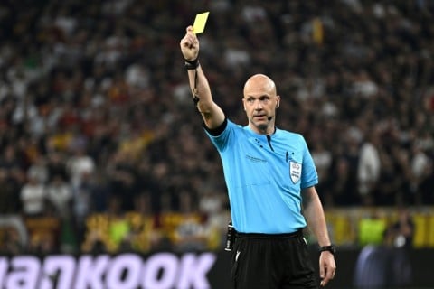 English referee Anthony Taylor shows a yellow card during the UEFA Europa League final