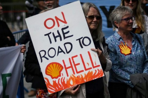 A climate activist holds a placard outside Shell's annual general meeting last month in London 