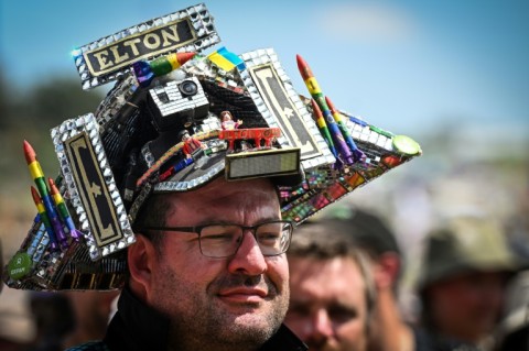 A festival goer awaits Elton John on day five of the Glastonbury festival