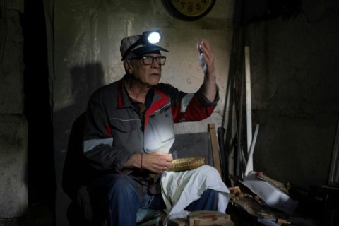 Grozdov's neighbour, 63-year-old Vitaliy Zemin, carves wooden animals to distract himself