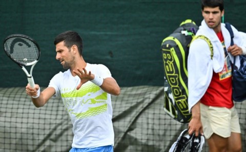 Close quarters: Carlos Alcaraz watches Novak Djokovic train at the All England Club on Sunday