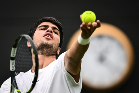 Spain's Carlos Alcaraz serves to France's Jeremy Chardy at Wimbledon
