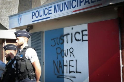 A protester holds a placard reading 'Abolish the police' as people gather to protest racism and police violence in Toulouse