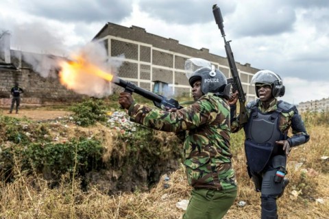 Tax demo: A police officer firing tear gas to disperse protesters in Nairobi
