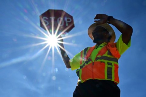 A traffic warden in Las Vegas mans his street corner in searing heat in Las Vegas, Nevada