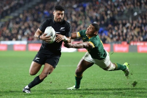 Richie Mo'unga (L) scores the last of four New Zealand tries in a Rugby Championship triumph over South Africa in Auckland on July 15, 2023.
