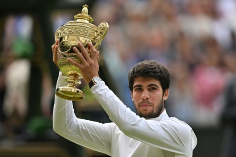 Champion: Carlos Alcaraz raises his trophy after beating Novak Djokovic 