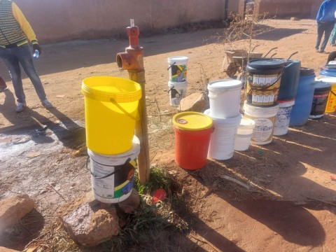 People queueing with buckets to get water. eNCA/Hloni Mtimkulu