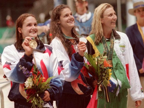 From L: US Whitney Hedgepeth (silver), US Beth Botsford (gold) and South African Marianne Kriel (bronze) smile on the podium after receiving their medals for women's Olympic100m backstroke 22 July at the Georgia Tech Aquatic Center in Atlanta. 