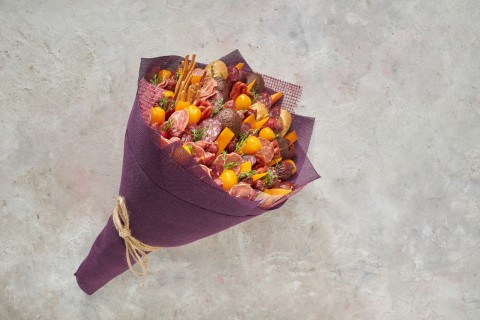 Tasty edible bouquet consisting of sausages, cheese. GettyImages/ovbelov