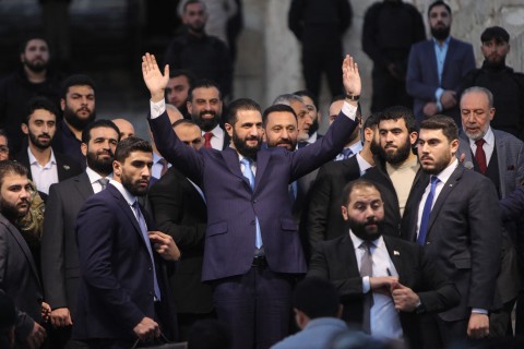 Syrian President Ahmed al-Sharaa waves to the crowd at the gate of Aleppo’s Citadel. AFP/Bakr Alkasem