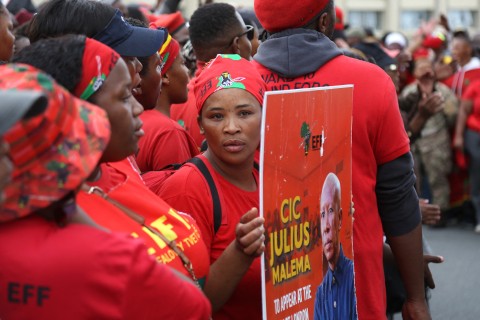 A supporter holds a placard of Economic Freedom Fighters (EFF) leader Julius Malema as they gather ahead of his arrival at the KuGompo City Regional court in East London on April 15, 2026 for his sentencing for firing an assault rifle at a rally eight years ago.