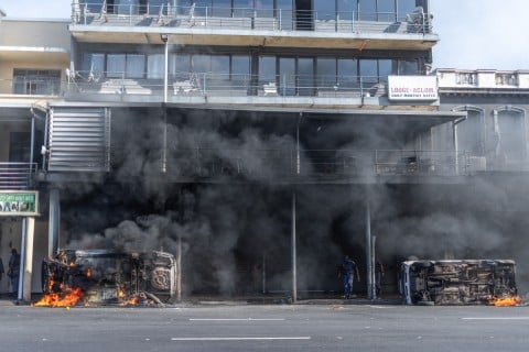 Cars are set alight after clashes erupt between protesters and foreign nationals in Durban on October 8, 2026.