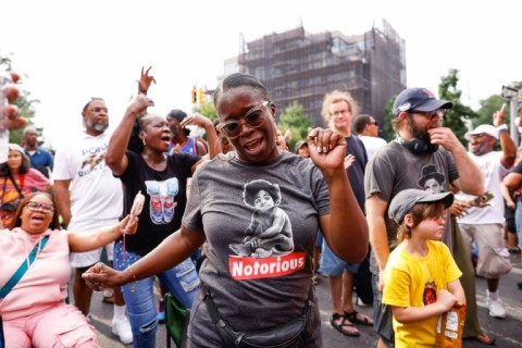 Attendees dance as US DJ Mister Cee plays during the 50 years of Hip-Hop celebration block party in Brooklyn, New York, on August 5, 2023
