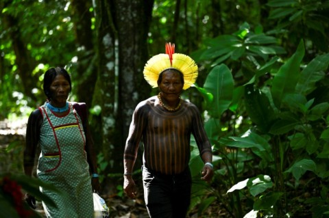 A Brazilian Indigenous leader, Tabata Kayapo, (R) walks at an Indigenous camp in Belém, the Brazilian city hosting a summit of the eight-nation Amazon Cooperation Treaty Organization as it seeks a roadmap to protect the world's biggest rainforest