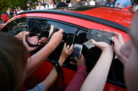 Bayern Munich fans take photos as Harry Kane arrives at hospital in Munich for his medical