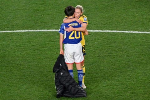 Sweden defender Jonna Andersson hugs Japan's Maika Hamano 