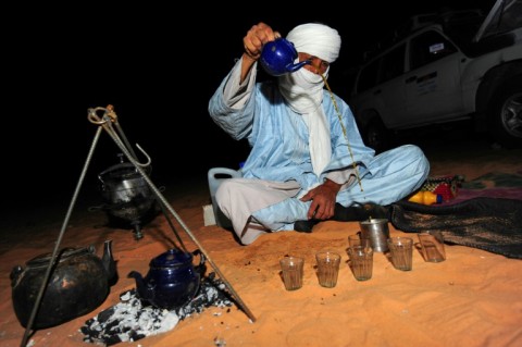 Pouring tea at a desert camp near the oasis town of Djanet