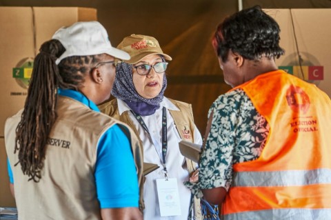 African Union election observers talking to a Zimbabwe Electoral Commission (ZEC) official on Wednesday at a polling station in Bulawayo, the country's second largest city